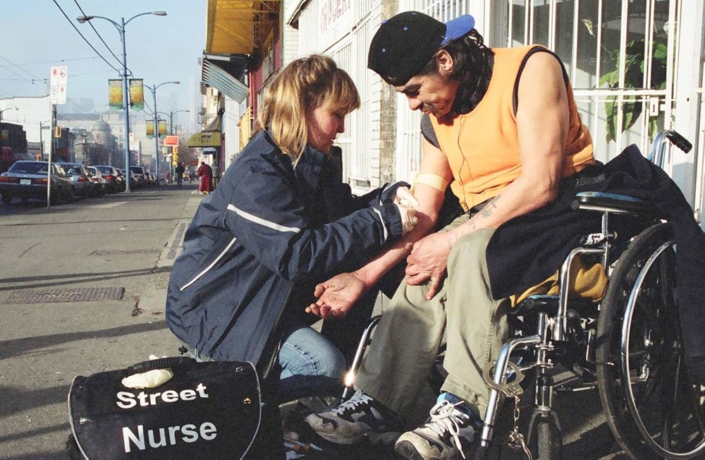 Street nurse attends to a patient